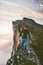 Man walking alone on the edge mountain ridge