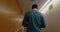 Man walking along the hotel corridor back to the
