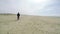 Man walking away on a beach