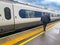 Man walking away from train in train Staton for rail strike industrial action concept UK