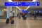 Man walking with baggage and top view of Terminal B Ticketing and Check-in sign at Orlando Internat Orlando International Airport