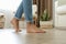 Man walking barefoot at home, closeup. Floor heating concept