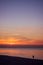 Man walking on the beach at sunset