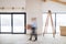 A man walking with cardboard boxes when furnishing new house. Motion blur.