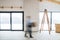 A man walking with cardboard boxes when furnishing new house. Motion blur.