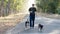 Man Walking Dogs on Country Road