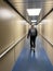 A man walking down a jetway to board an airplane