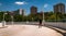 Man walking down a parking garage ramp, looking at highrises in