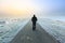 Man walking on an empty desolate raod