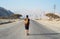 Man walking on the empty dessert road