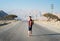 Man walking on the empty dessert road