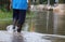A man walking on the flooded road