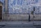 Man walking in front of  traditional portuguse tiles