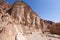 Man walking hiking deep desert canyon.