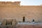 Man walking through the interior of the Edfu Temple. Egypt April 2019