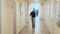 Man walking through a long corridor