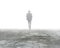 Man walking in mist on dirty concrete floor