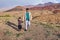 Man walking on mountain plateau with little boy, Abyaneh, Iran.