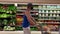 A man walking next to the vegetable aisle at a Publix grocery store