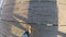 Man walking on old wooden pier enjoying the bright autumn sunshine