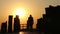 Man Walking Over Wooden Bridge at Sunset