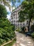 A man walking in a park in a traditional Haussmann neighborhood in Paris