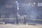 Man walking past burned industrial building