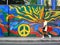 A man walking past a street wall art