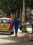 Man walking with rainbow flag at LGBTQI march gay parade pride celebration event through streets of Medellin Colombia