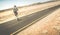 Man walking on the road on namibian african desert