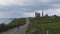 A man walking on a road. spring, flowers and cloudy sky. Tankardstown mine. Copper Coast Geopark