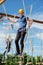 Man walking on a rope ladder