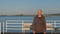 Man walking on sea pier. Portrait adult man standing on sea pier