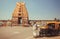 Man walking to 12th century Chennakeshava Temple with carved tower gopuram