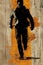 A man walking on a wooden plank with orange paint splatters, AI