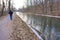 Man walks along frozen canal aside Delaware River