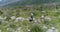 Man walks along a mountain trail with a backpack.