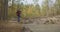 A man walks along a path in a park near a lake in the early morning in the autumn. Man Hill Top. Young Man Standing On