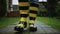 A man walks along the track in large black and yellow, striped rubber boots