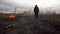 Man walks on a burning field in the steppe