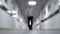 A man walks down the corridor. Blurred background. Young man walking down the long corridor