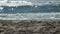 man walks early in the morning along the coastline of the sea on clean soft sand