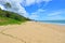 Man walks on Ellis beach in Cairns Queensland Australia