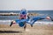 man walks with equipment to practice wing foil on the beach