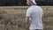 A man walks through a field of wheat