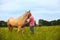 A man walks with his horse