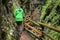 Man walks over wooden stairs through a water gorge in Austria