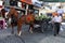 A man walks past a horse and cart loaded with watermelons parked on a street at Ayvalik in Turkey.