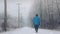 Man Walks On Road In The Snow