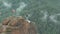 A man walks on a rope stretched at an altitude between two peaks in the Siberian nature reserve Stolby.